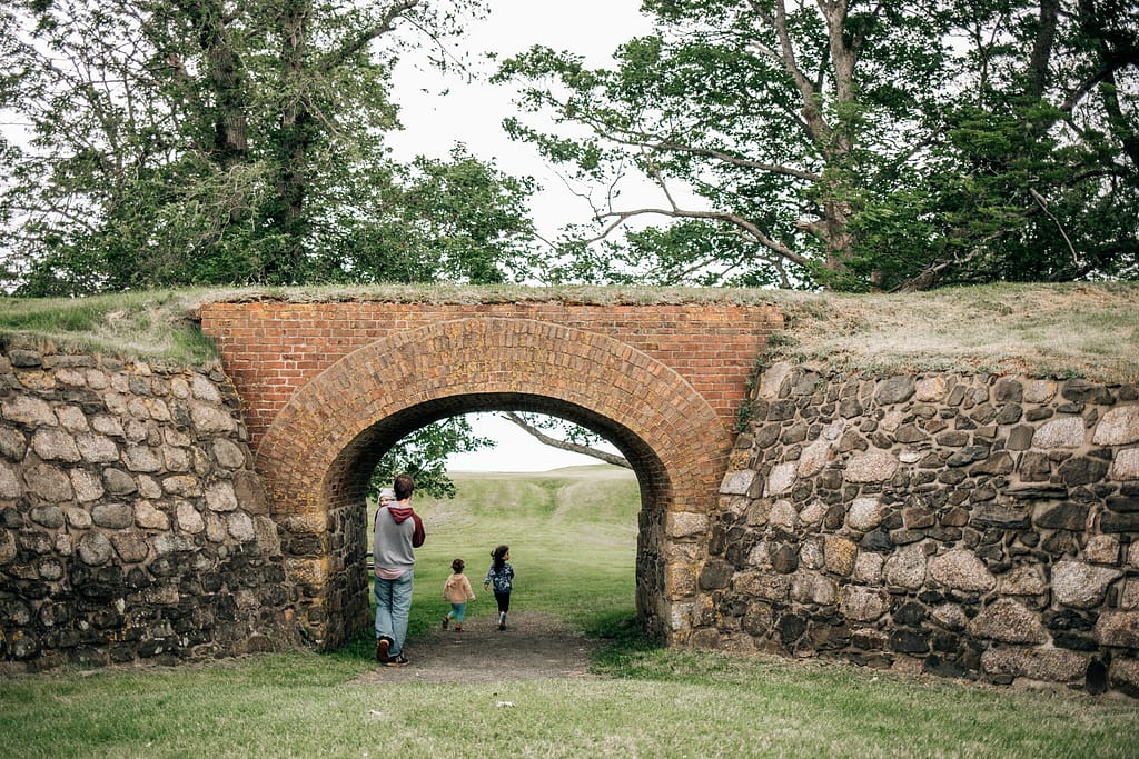 Family exploring Fort Anne Historical Site in Annapolis Royal, Nova Scotia