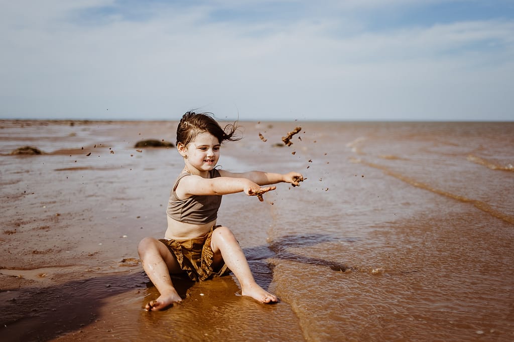 Child playing in sand at Blomidon Provincial Park