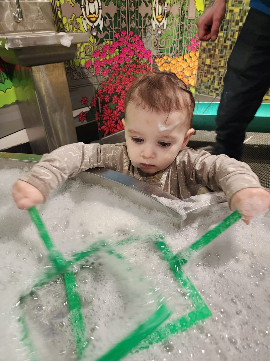 toddler playing in bubble room at the discovery center in Halifax, NS