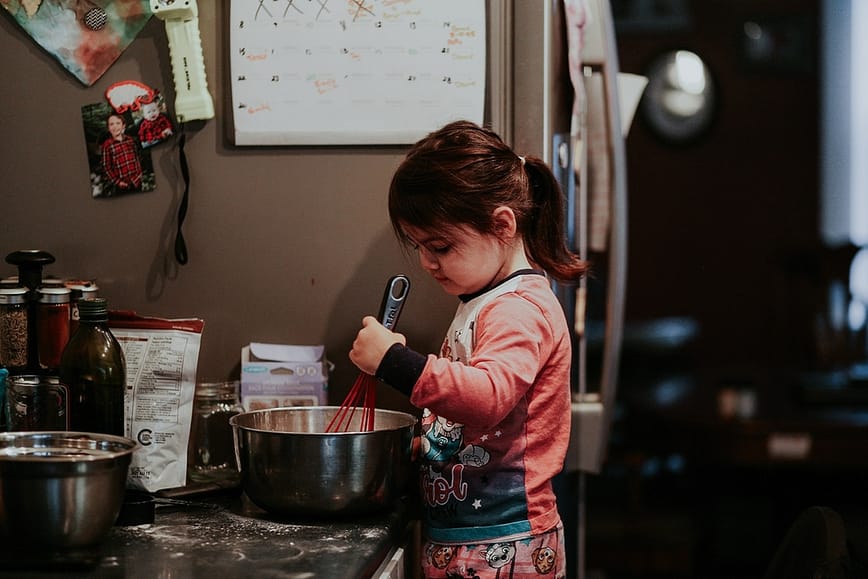 Young girl stirring ingredients in bowl