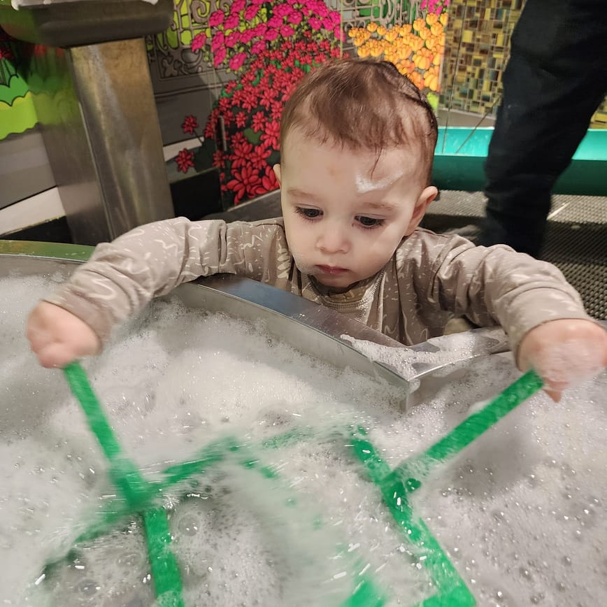 toddler playing in bubble room at the discovery center in Halifax, NS